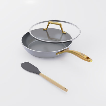 Asai Ceramic Frying Pan in Clay Grey with gold handle, lid and silicone spatula